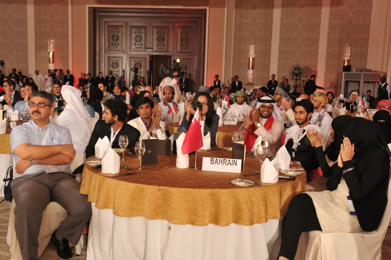 a large group of people seated around a round table