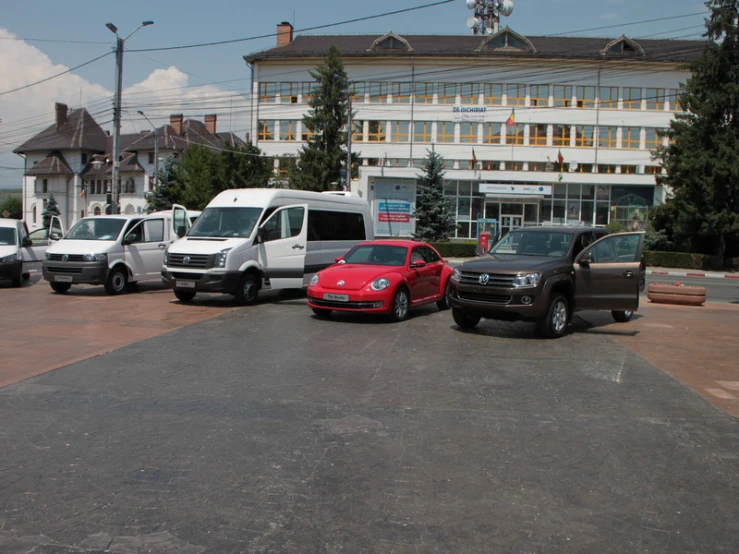 several different vehicles are parked outside in the lot