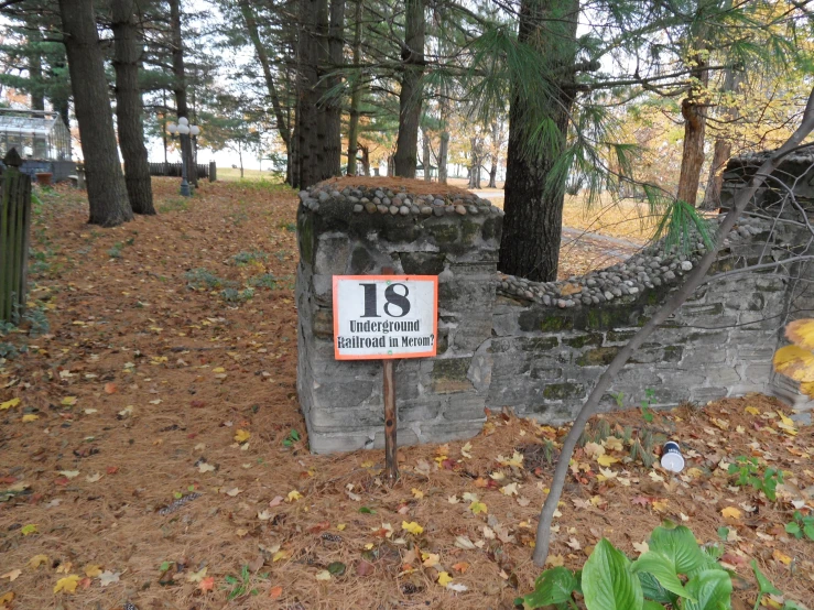 a small gated entrance to a park with a sign stating the number thirteen