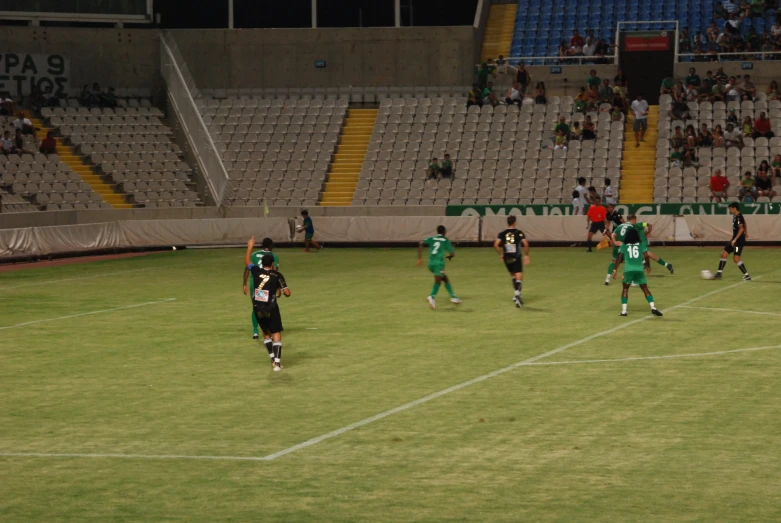 a group of soccer players play on the field