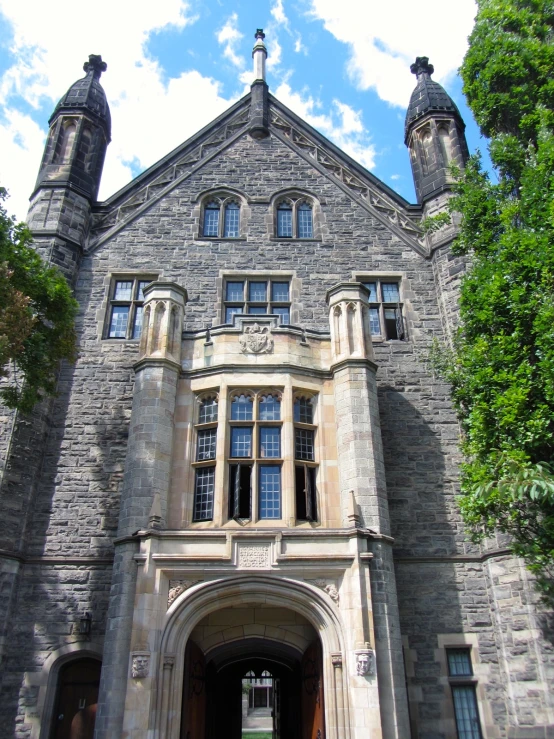 there is a very tall and old gray building with arches