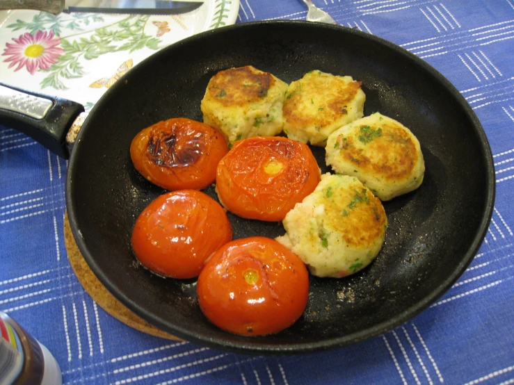 some food is cooked in a set with tomatoes