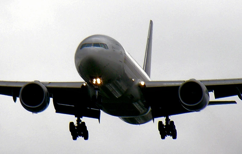 a large airplane flying in the sky during the day