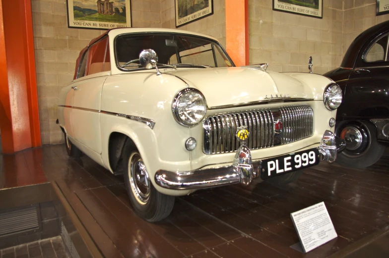 there are some cars on display in this museum