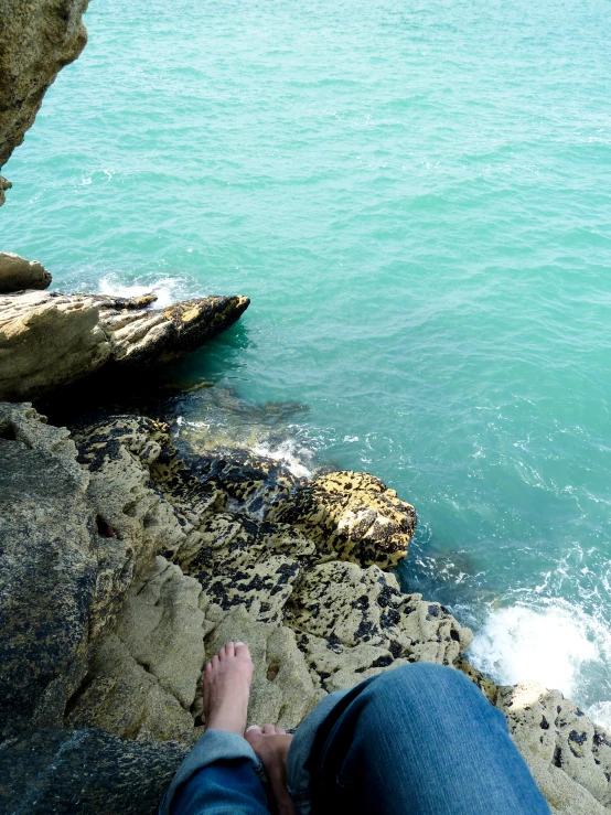 a person laying down next to a rock