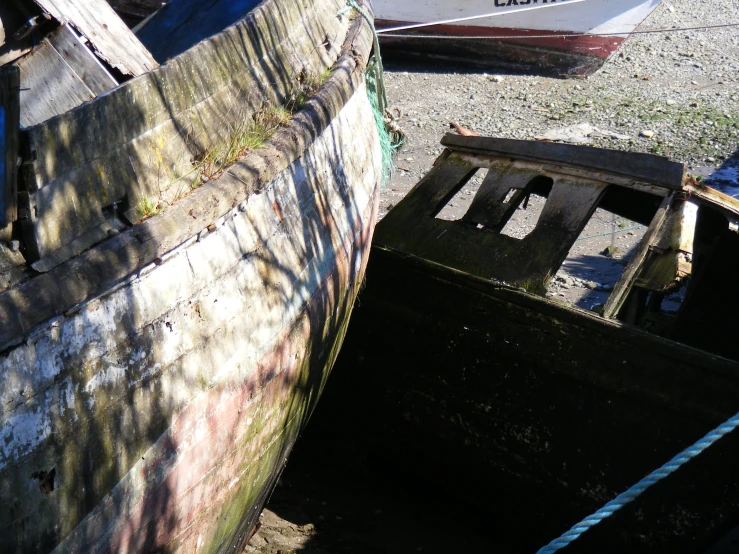 a boat with faded paint sitting next to another boat