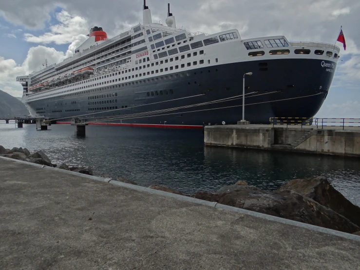 a large cruise ship in the water by a dock