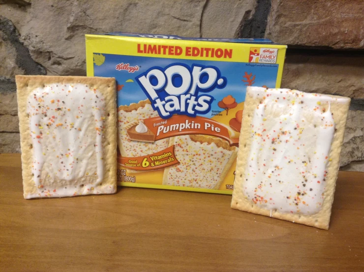 the two boxed pieces of sprinkled white frosted pop tarts are next to a box of gummy pee