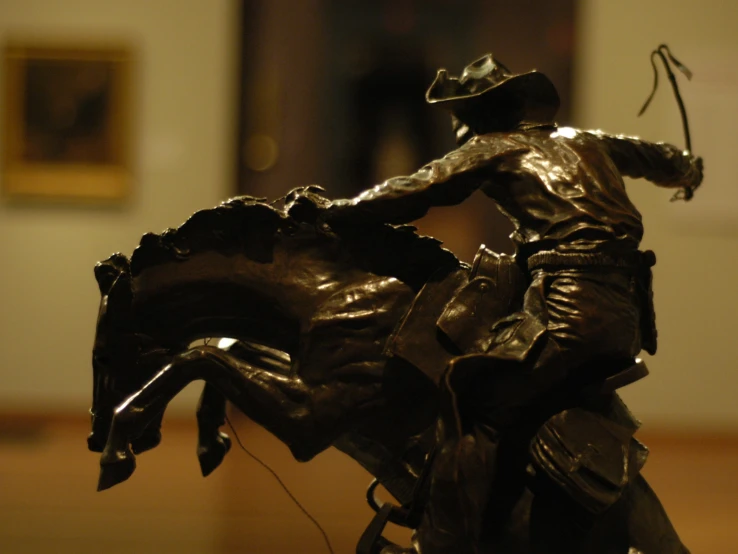 a small bronze statue of a man on a horse