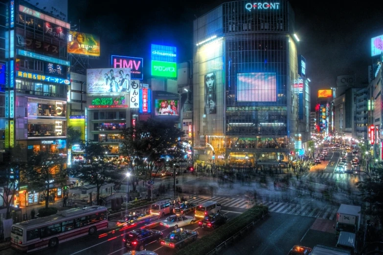 a busy city street with a variety of neon buildings and neon signs lit up at night