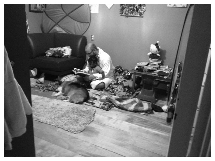 a woman is sitting on the floor reading a book