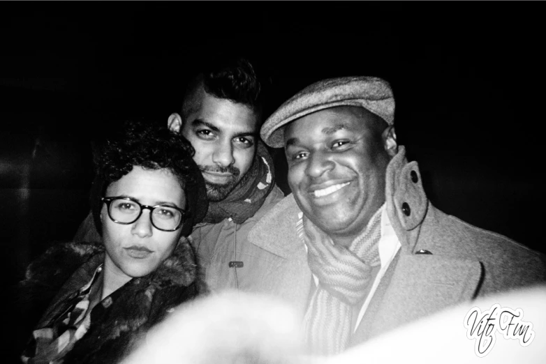 a black and white po of three men with glasses and a woman