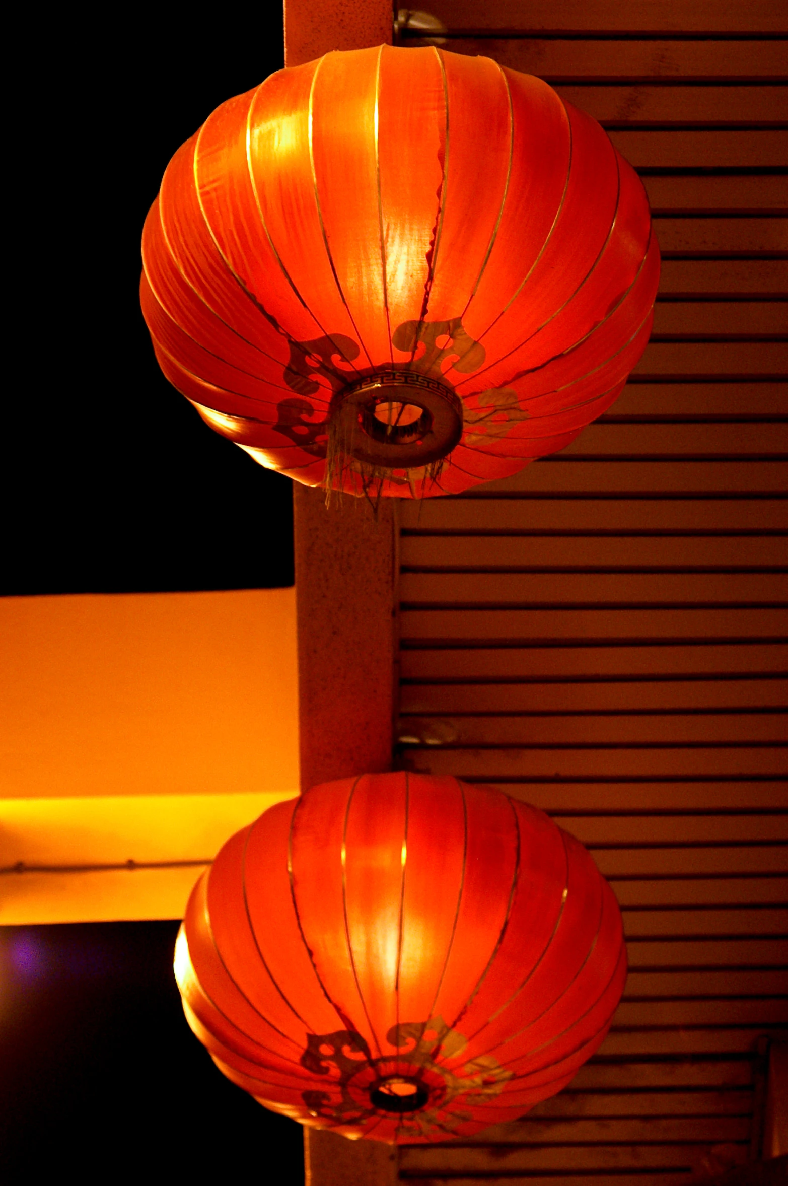 two lit up red lanterns sitting next to each other