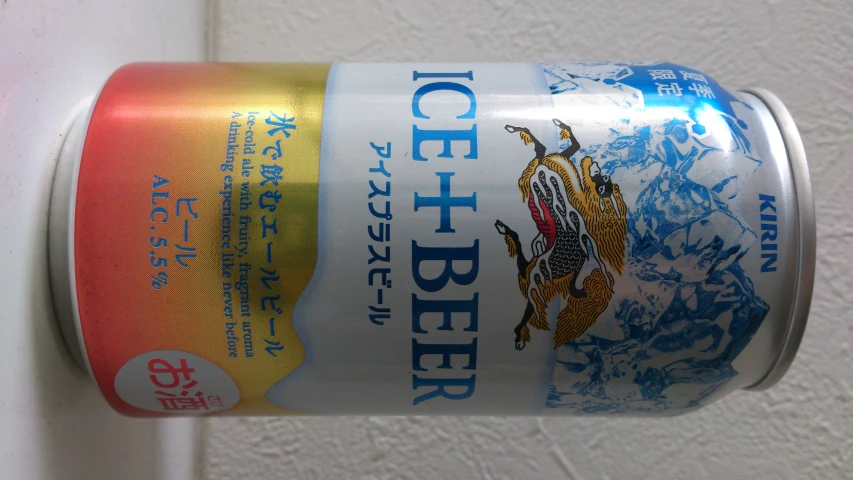 the can of ice beer is bright red, yellow and blue
