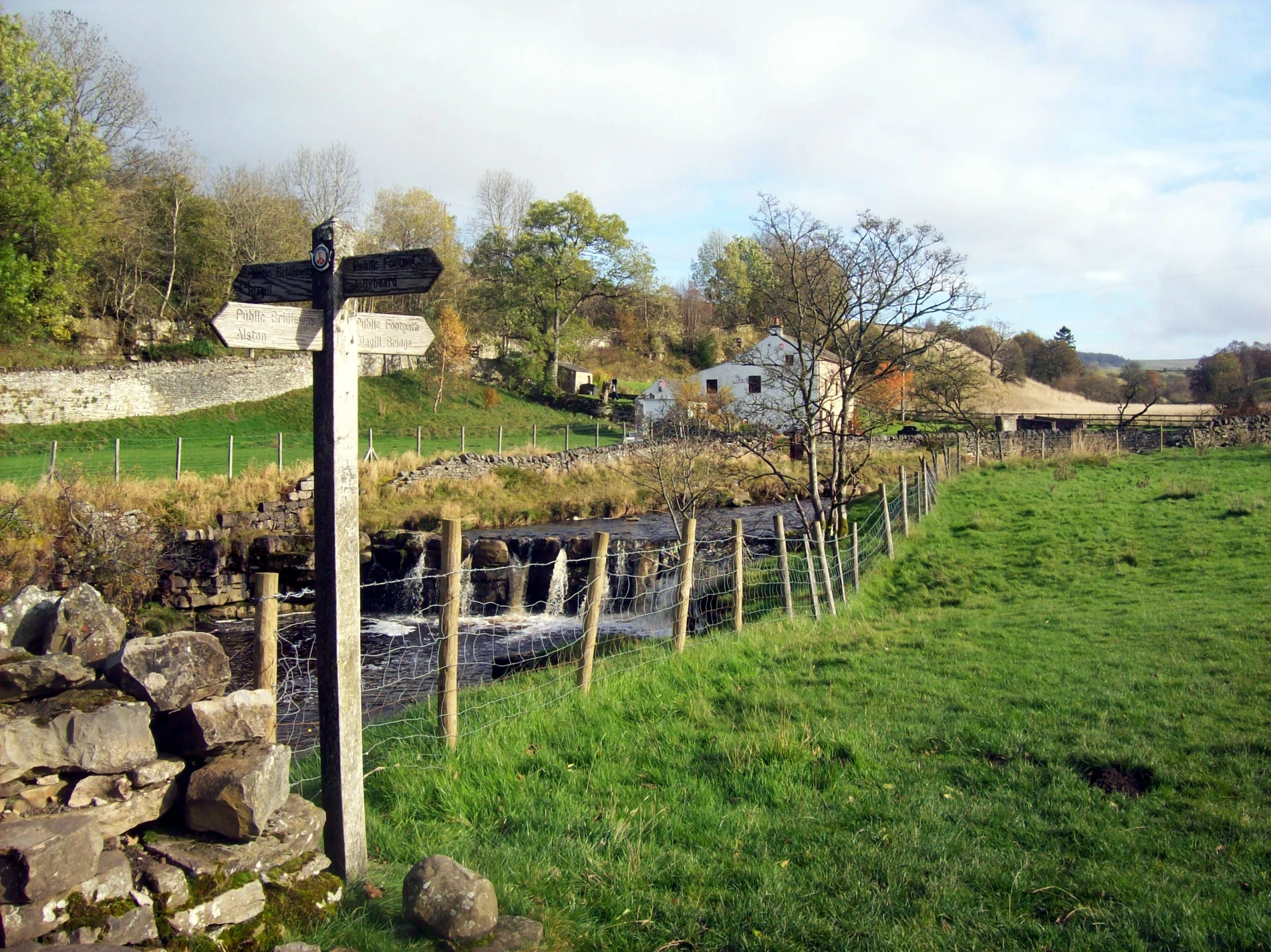 a large field with rocks near a river