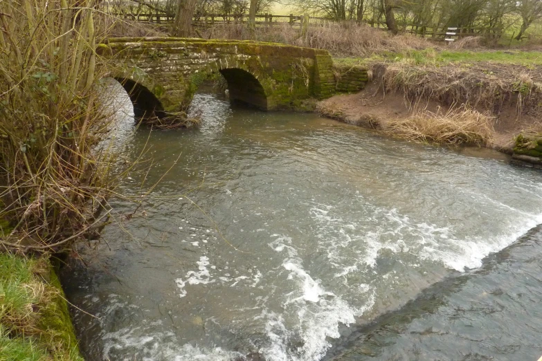 water is flowing under a small bridge