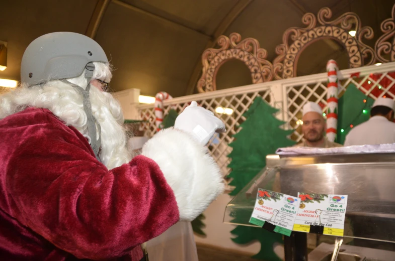 santa claus in an ice cream kiosk with other people