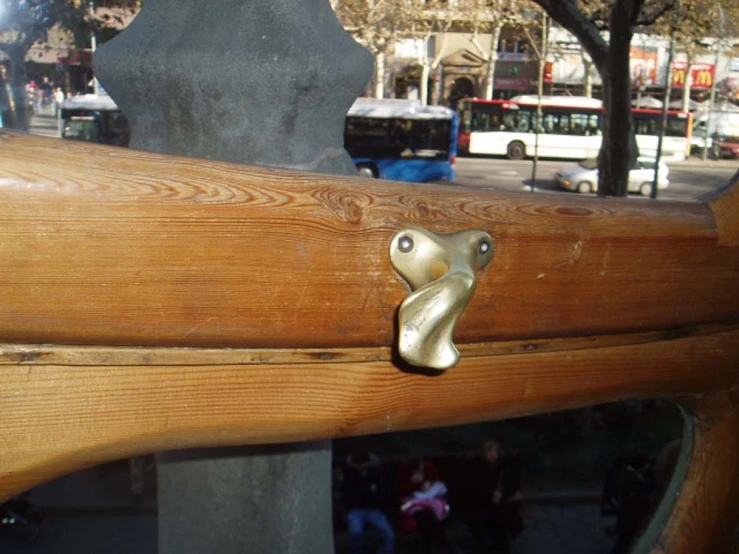 a close up of a wooden fence with metal handles