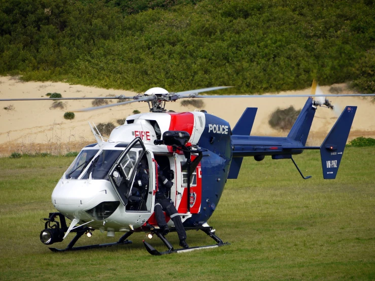 a couple of people getting ready to board a helicopter