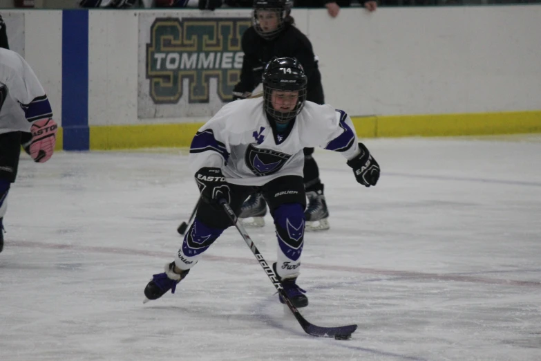 a young man skating on an ice rink