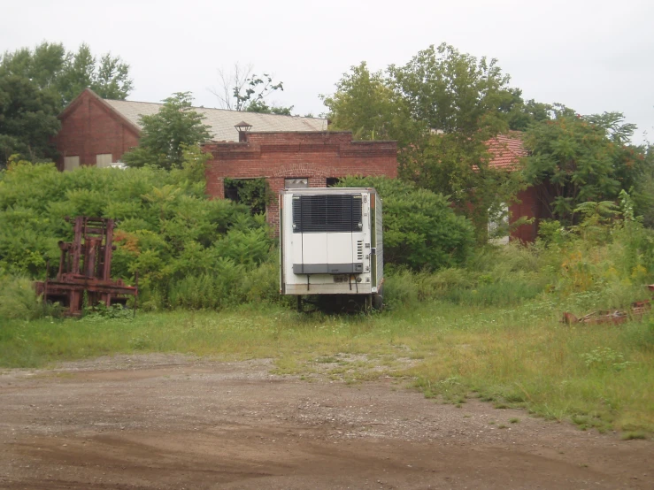 an old truck parked on the side of a dirt road