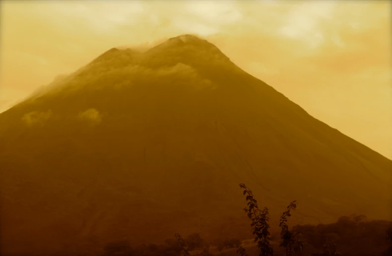 an old po of a cloud covered mountain