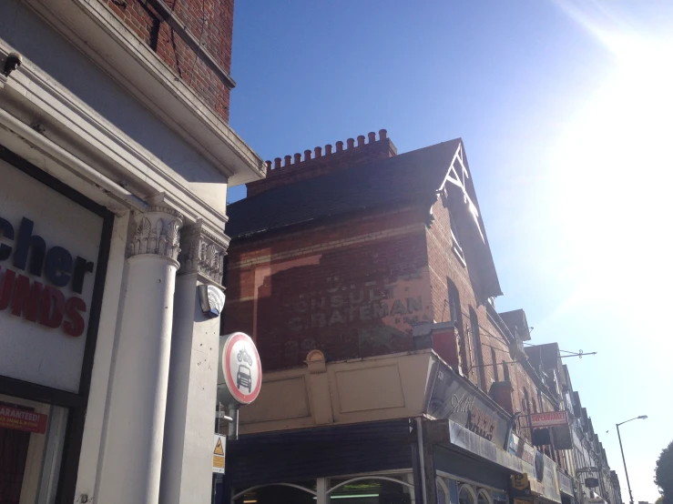 a tall brick building sitting on the side of a street