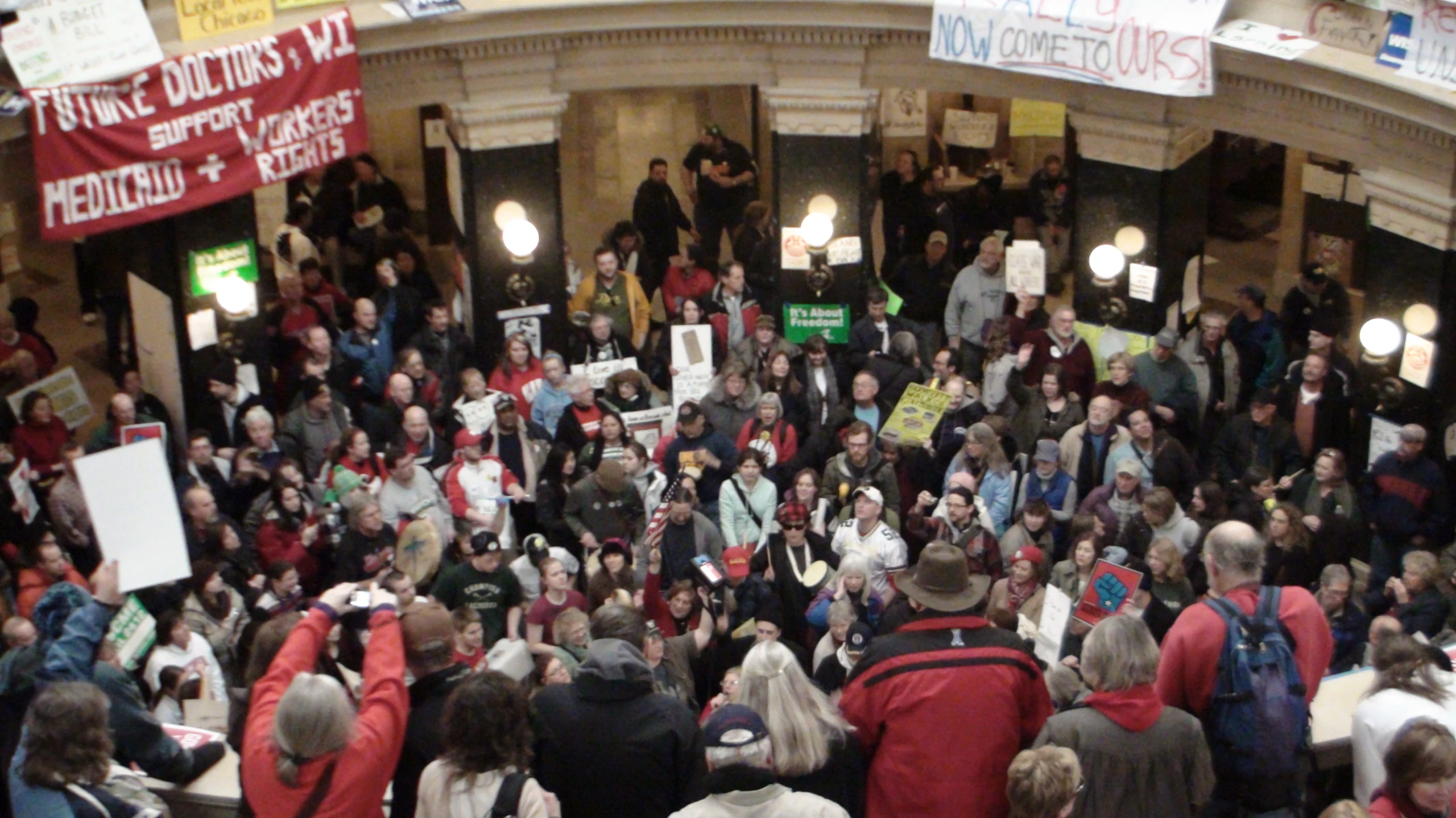 a large crowd of people standing in a building