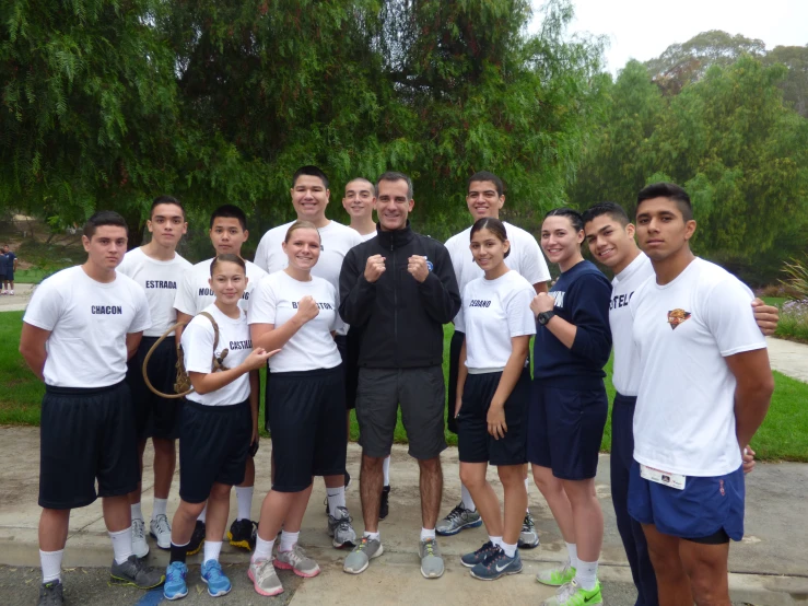 some people posing with two tennis rackets in their hands