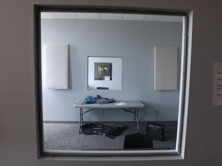 a mirror view looking into a room with furniture