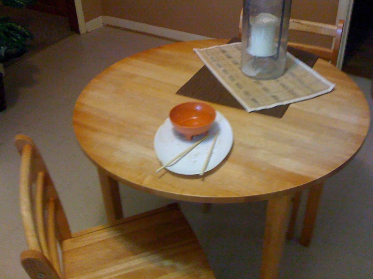 an orange sits on a white plate on the table