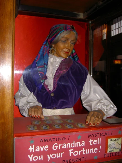 an old lady in costume is sitting in front of a box