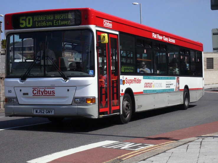 a large red and white bus on a street