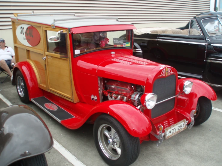 there is a vintage car and a classic one in the parking lot