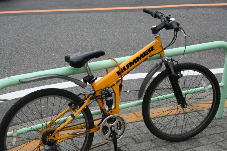 a yellow bike parked on the side of a road