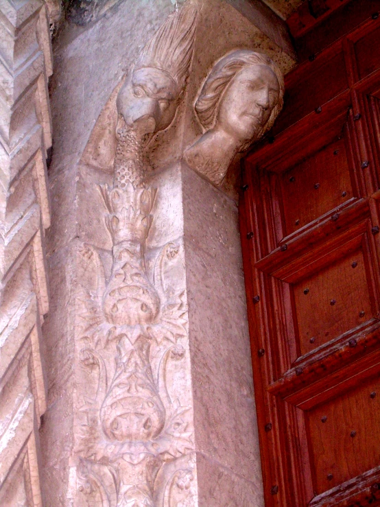 carvings and door in front of building in city