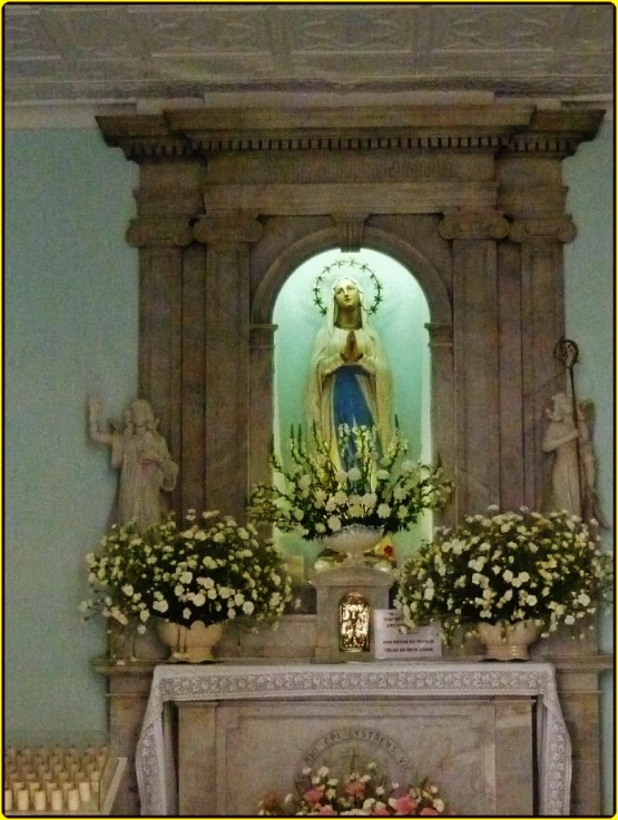 a white fireplace with flower arrangements sitting under a mantle