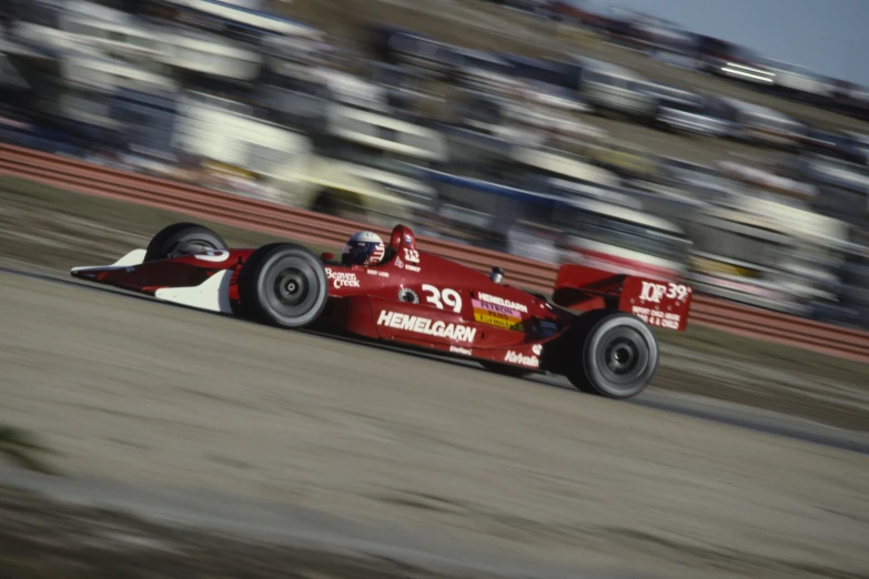 a red race car on the road during an event