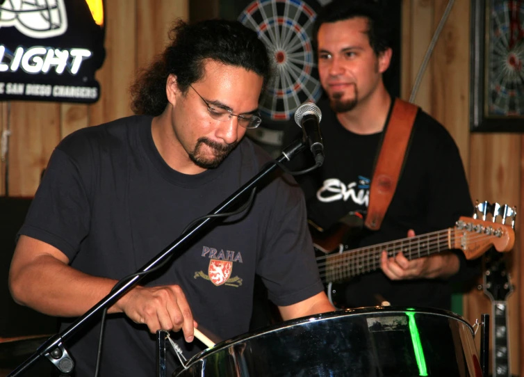 two men are playing a song on stage