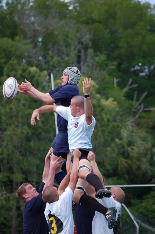 a group of men in blue and white uniforms are playing ultimate frisbee