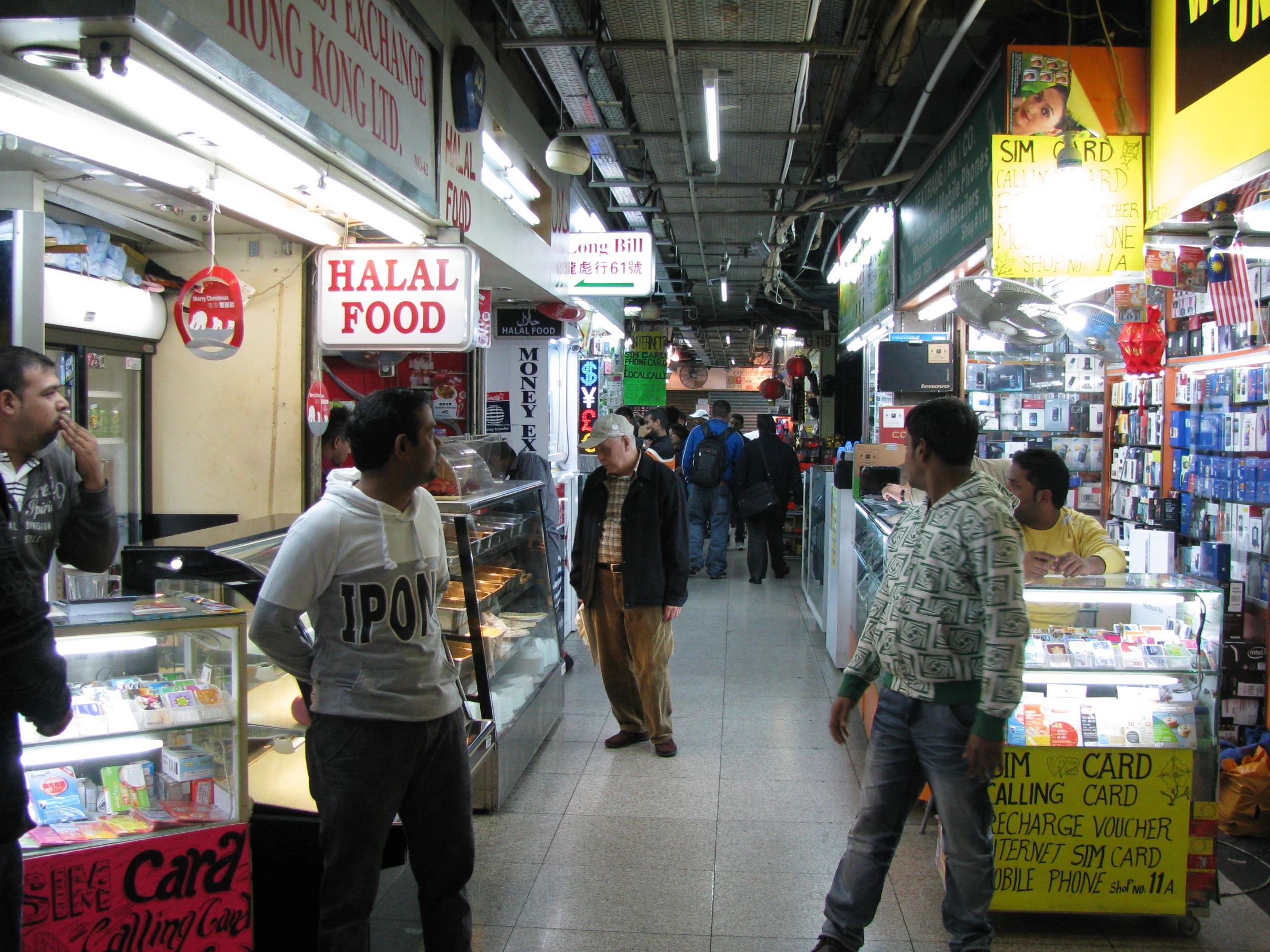 a busy market with a few vendors in the background