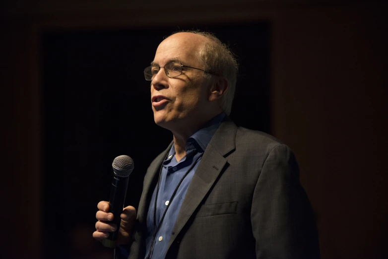 a man with a microphone stands in front of him