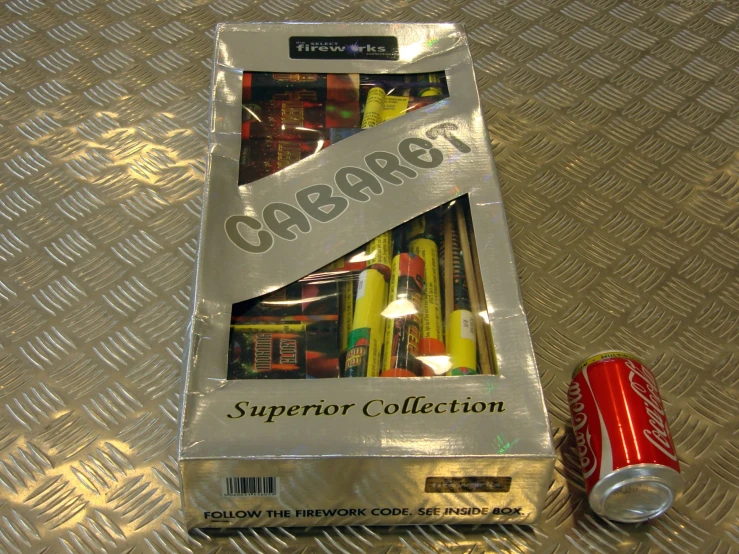 an open package of cigarettes and a can