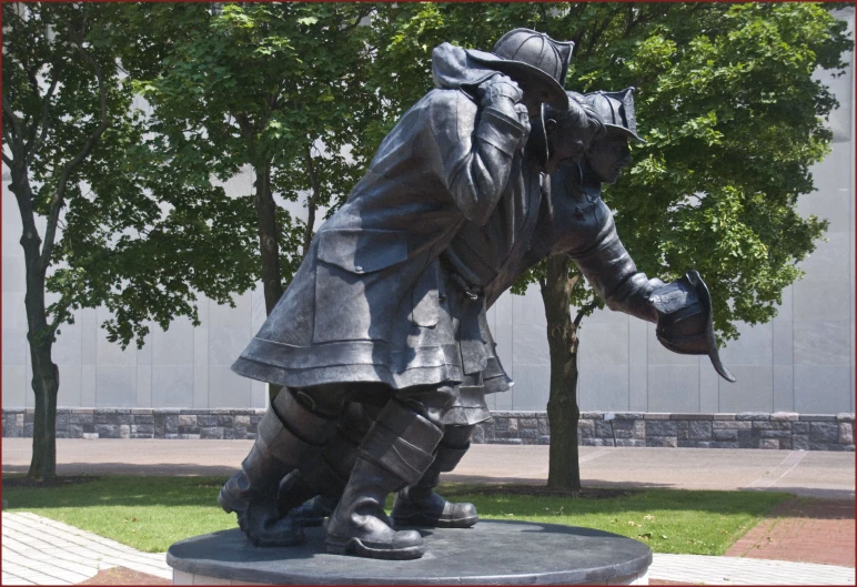 statue of a man kneeling in a park area