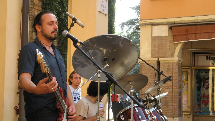 a man playing music at an outdoor stand