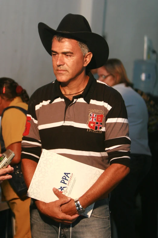 a man wearing a black and brown striped shirt