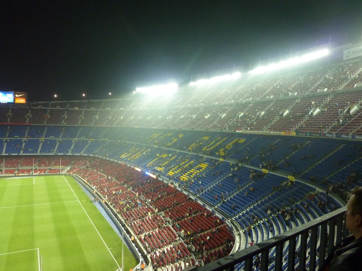 many people are watching a large soccer game at night