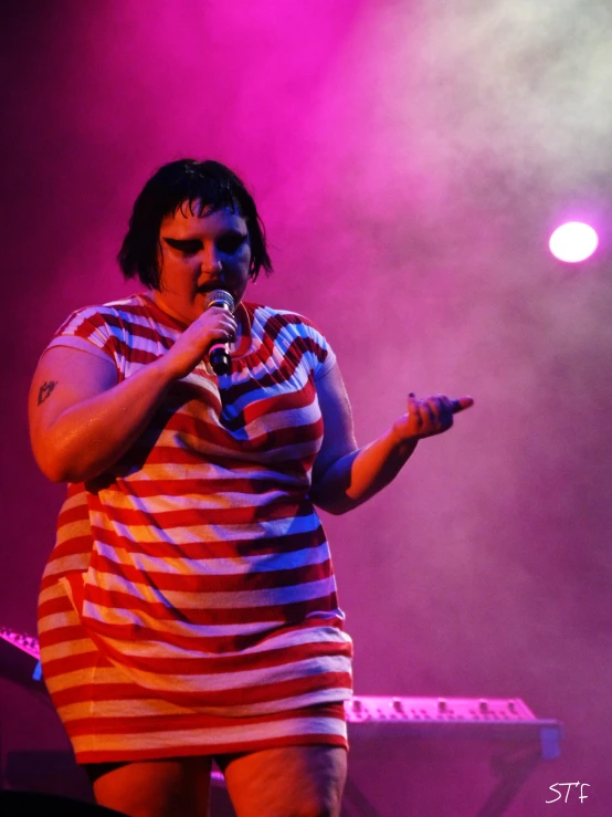 a female singer performing on stage at a music festival