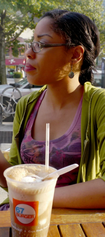 a woman is holding a plate of food and smiling