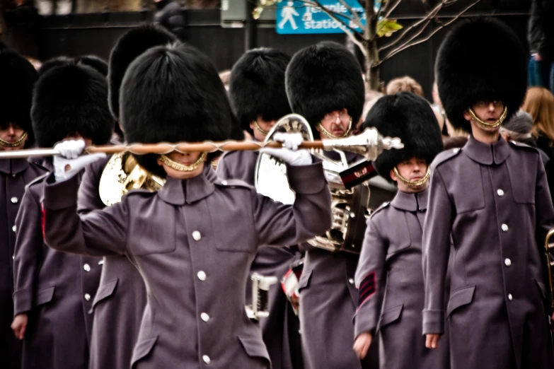 a group of men in uniform marching with their own music instruments